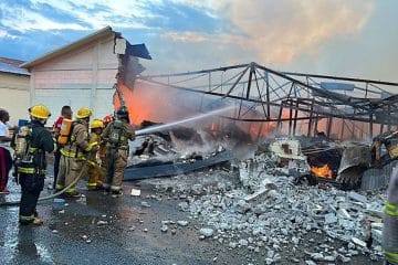 Firefighter extinguishing Arturo Fuente warehouse fire